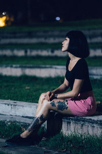 Young woman sitting outdoors