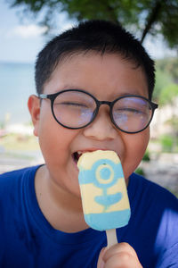 Close-up of boy eating popsicle