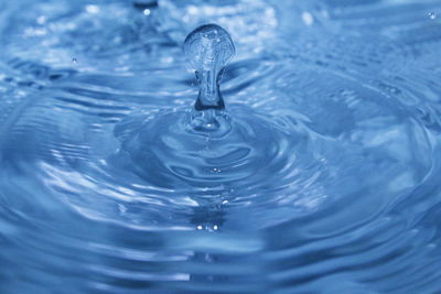 Close-up of drop falling on water