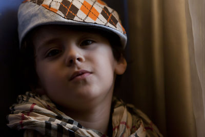 Close-up portrait of cute boy at home