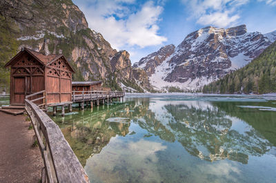 Scenic view of lake by buildings against sky