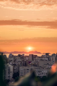 Cityscape against sky during sunset