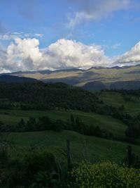 Scenic view of landscape against cloudy sky