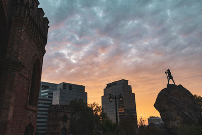 Low angle view of buildings against sky during sunset