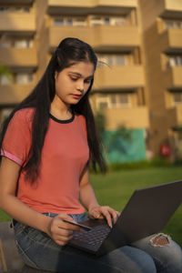 Young woman using laptop at home