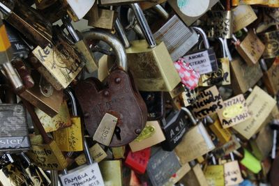 Close-up of padlocks hanging on railing