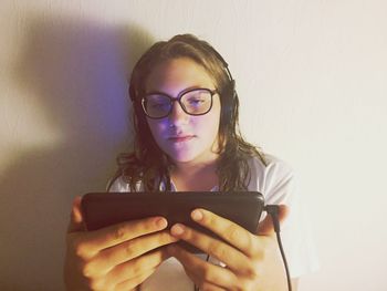 Portrait of girl holding mobile phone
