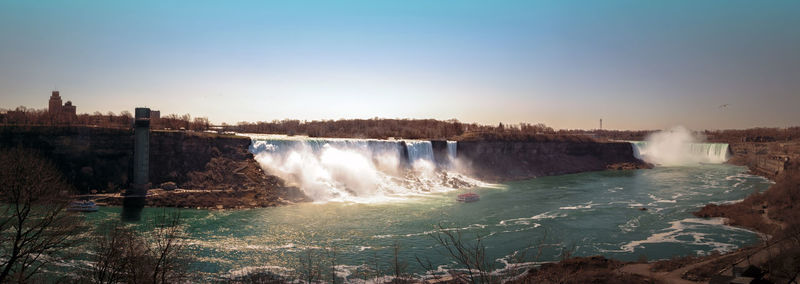 Scenic view of waterfall against sky