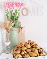 Flowers in vase and baked pastry items on table