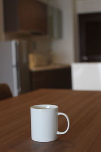 Close-up of coffee cup on table at home