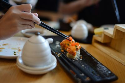 Close-up of person preparing food on table