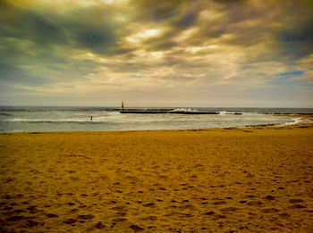 Scenic view of sea against cloudy sky