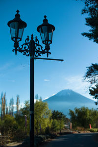 Road sign on mountain against blue sky