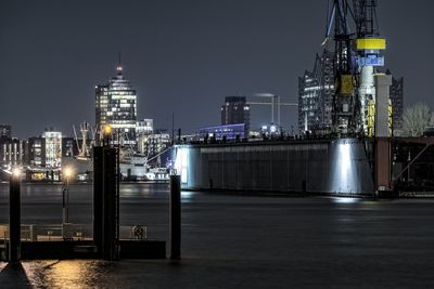 Illuminated port of hamburg in city at night