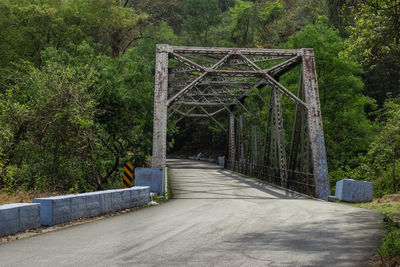 Old iron bridge in deep green forest