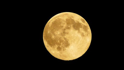 Low angle view of moon against clear sky at night
