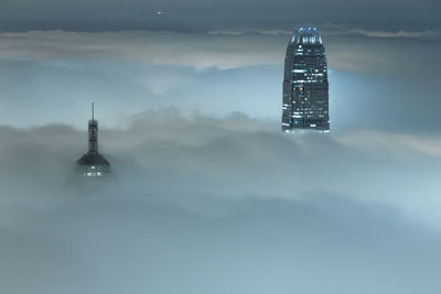 View of illuminated tower against cloudy sky