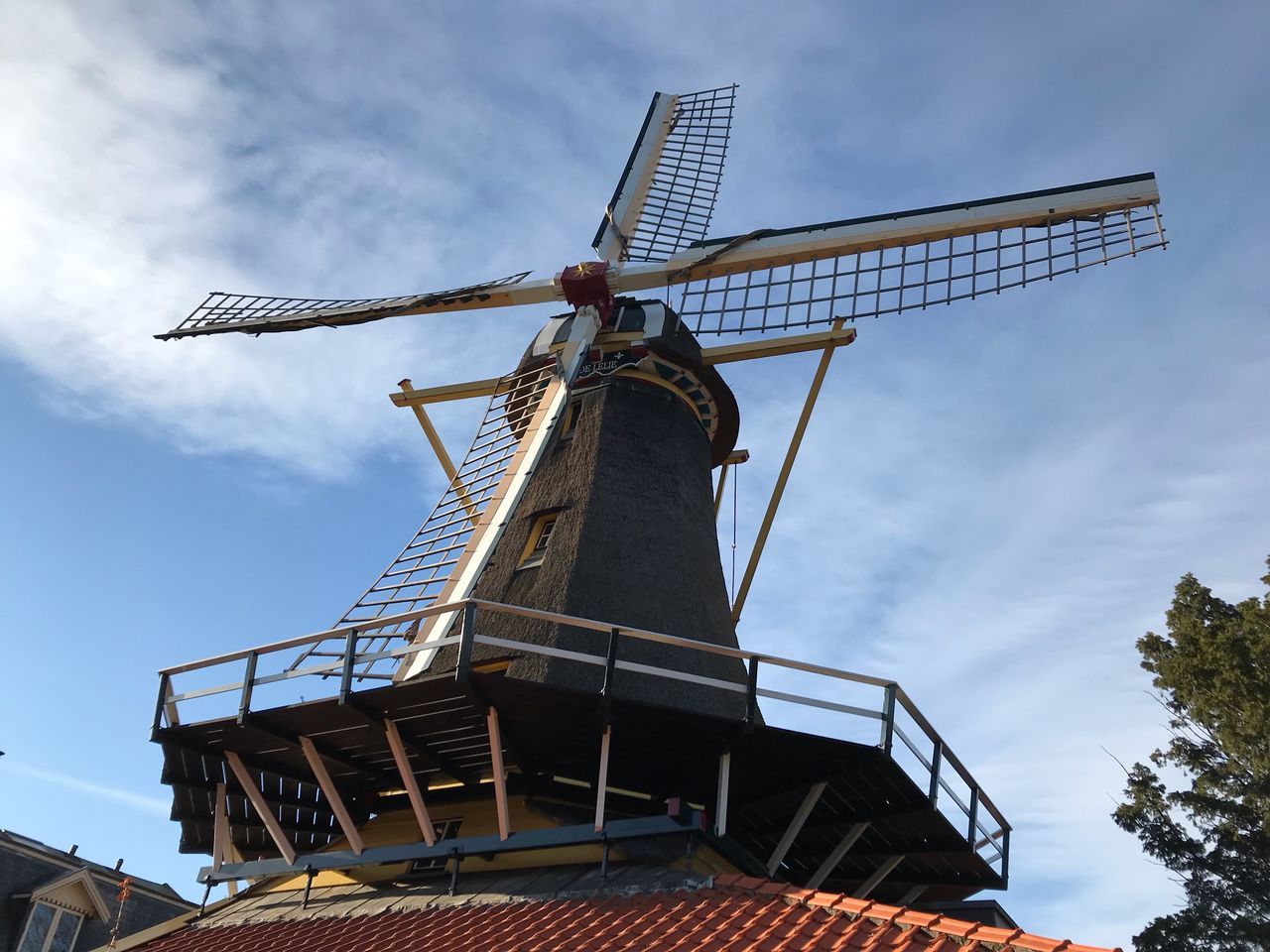 renewable energy, sky, alternative energy, environmental conservation, wind power, wind turbine, low angle view, traditional windmill, turbine, fuel and power generation, cloud - sky, nature, architecture, built structure, environment, day, no people, outdoors, tree, blade