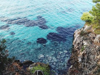 High angle view of rocks by sea