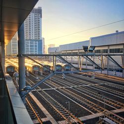 Railroad tracks in city against sky