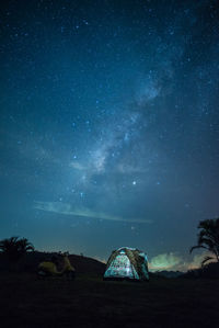 Tent on land against sky at night
