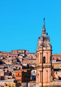 Low angle view of buildings against blue sky