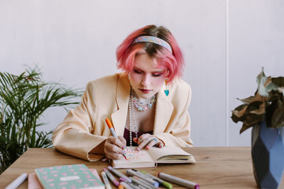 Portrait of young woman reading book