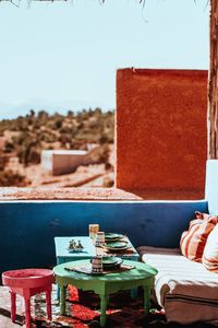 Close-up of drink on table at beach against clear sky