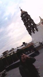 Low angle view of man against sky in city