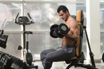 Muscular man exercising in gym