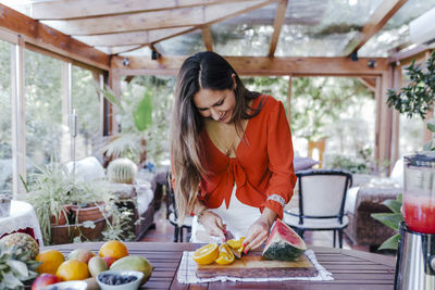 Woman holding food on table