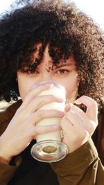 Close-up portrait of young woman holding drink