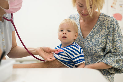 Portrait of cute girl with stethoscope on table