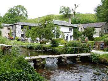 House by river against clear sky