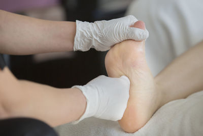 Cropped hands of giving foot massage at spa