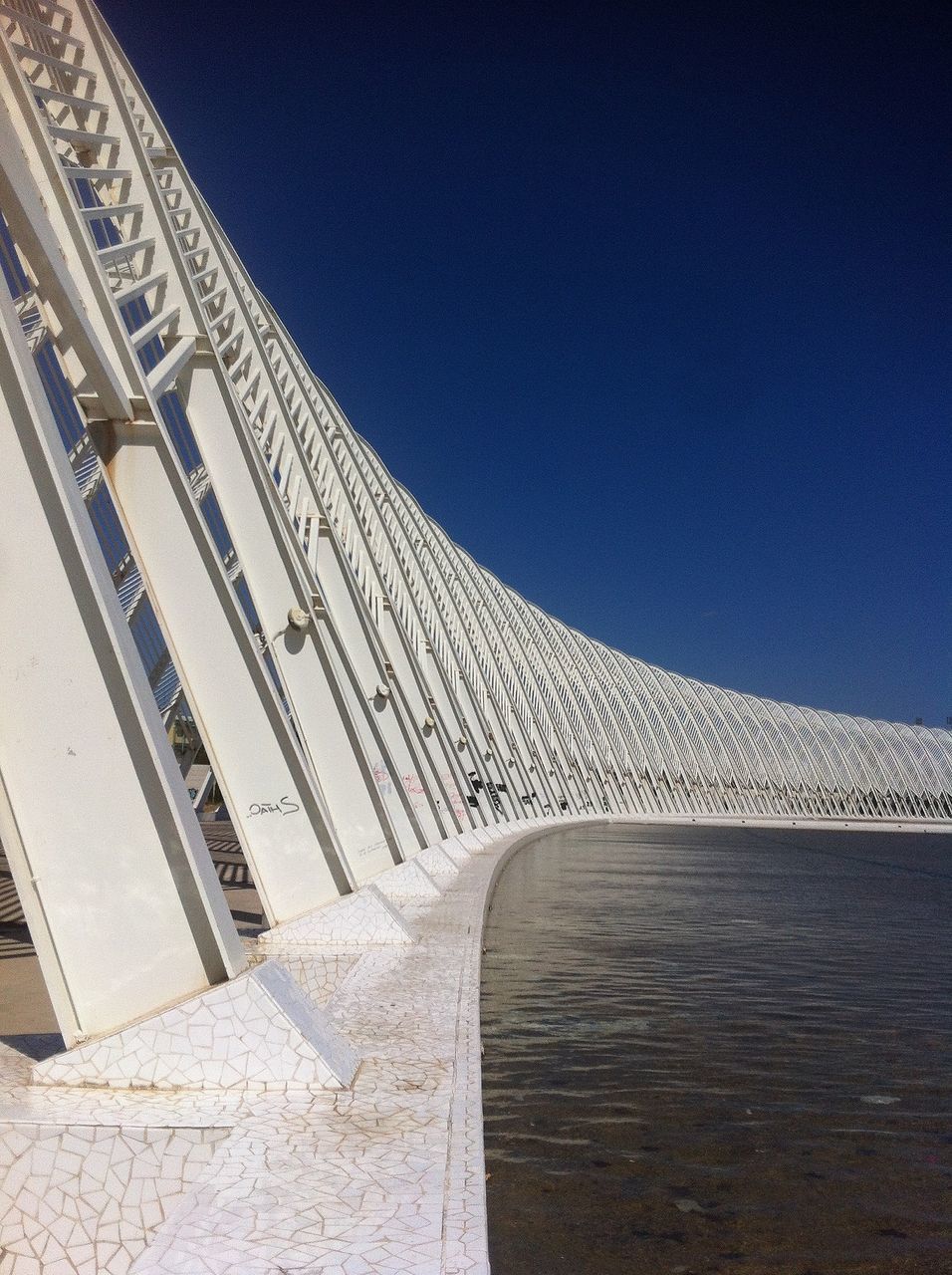 architecture, built structure, building exterior, clear sky, low angle view, copy space, the way forward, steps, building, sunlight, blue, architectural feature, wall - building feature, steps and staircases, railing, diminishing perspective, shadow, day, pattern, no people