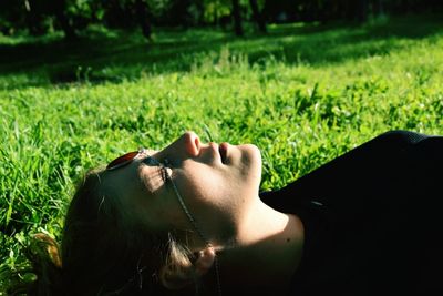 Close-up of woman relaxing on grass