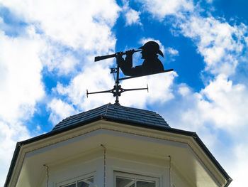 Low angle view of weather building against sky