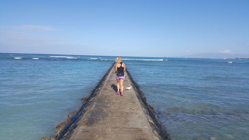 Woman on beach against sky