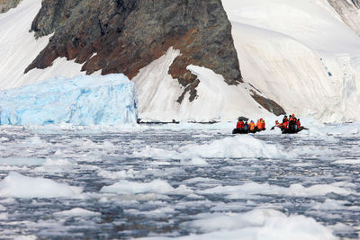 People skiing on frozen sea