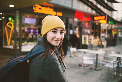 Portrait of a smiling young woman in city