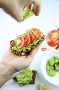  vegan avocado toast with tomatoes on white background. selective focus. view from above.