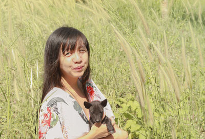 Portrait of smiling woman against plants