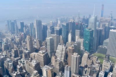 Aerial view of modern buildings in city against sky