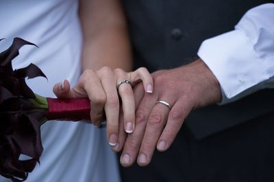 Midsection of couple holding hands