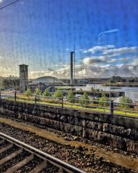 Railroad track against cloudy sky