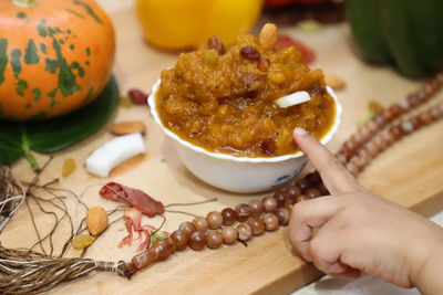 Close-up of person holding food on table