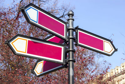 Low angle view of road sign against sky