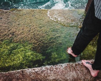 Low section of person standing on rock