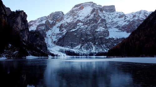 Scenic view of lake and mountains against clear sky